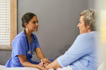 Cropped shot of a nurse holding a senior womans hands in comfort.